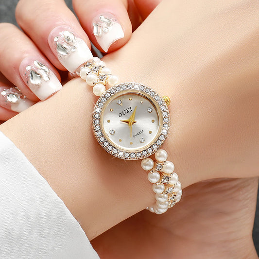 Shine with charming femininity a watch adorned with pearls and gold luster focused on attractiveness and beauty your wrist