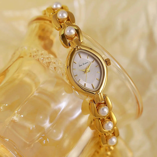Decorate your wrist with undead luxury with a delicate gold and pearl watch